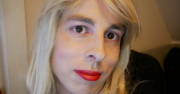 Close up portrait, focused on a person with blond hair and bright red lipstick