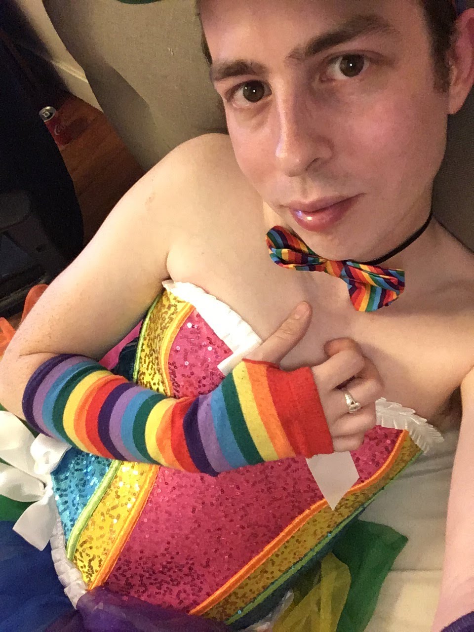 Wearing a rainbow corset, with rainbow arm warmers and a tutu.