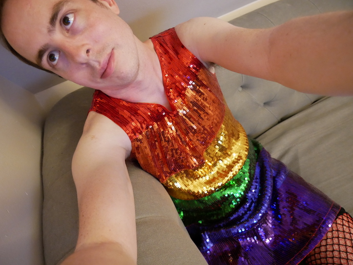 Man wearing rainbow-sequin dress